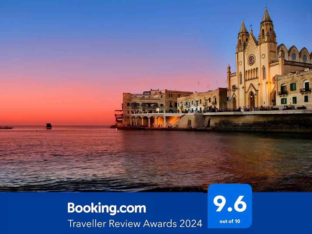 a view of a building with a sunset in the background at Antik Malta in Sliema