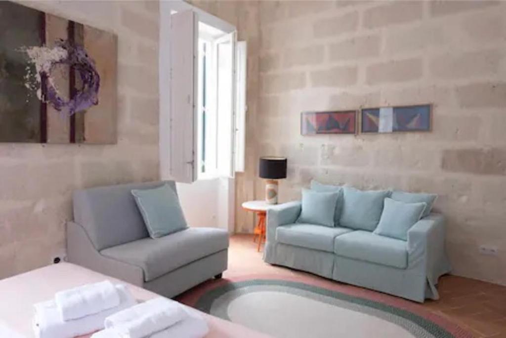 a living room with two chairs and a couch at Suite 2 in Mahón