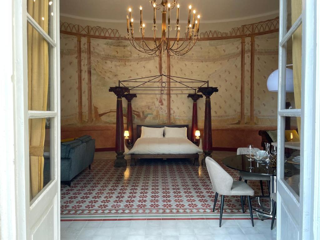 a bedroom with a bed and a chandelier at Il Sogno di Elisa in Lucca
