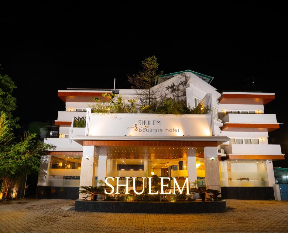 a building with a sign that reads shulmen at Shulem Boutique Hotel in Dimāpur