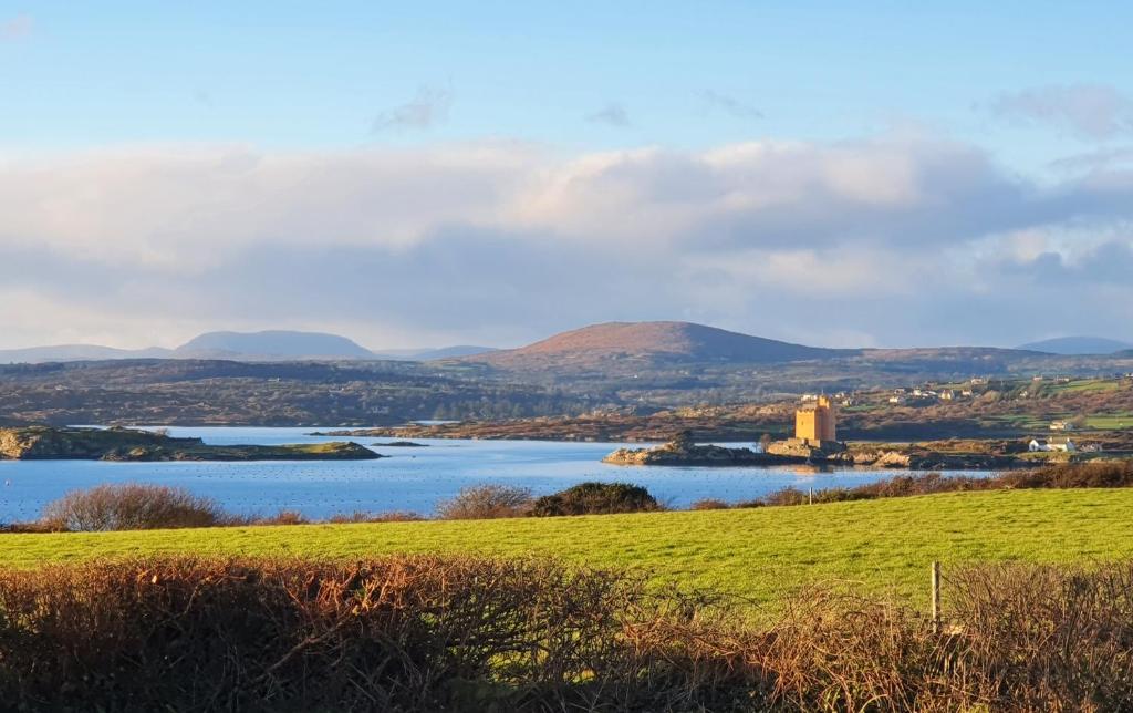 a view of a lake with mountains in the background at Roaringwater Stay in Skibbereen