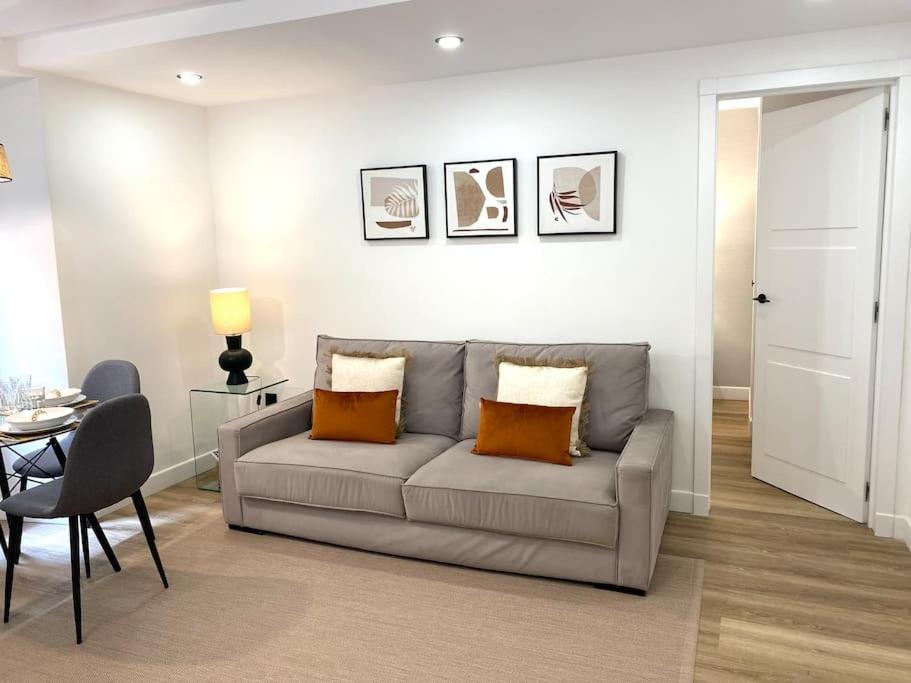 a living room with a couch and a table at Centric Lovely private flat 2BD, 2BH + AC in Madrid
