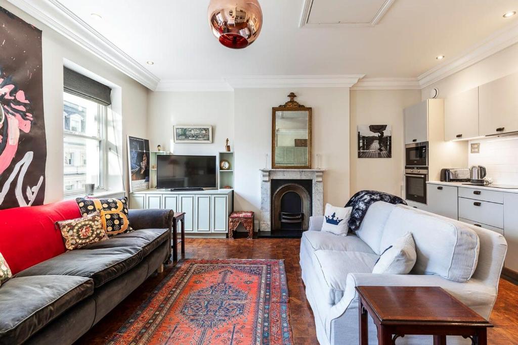 a living room with two couches and a fireplace at 1BR Chic Covent Garden Retreat in London