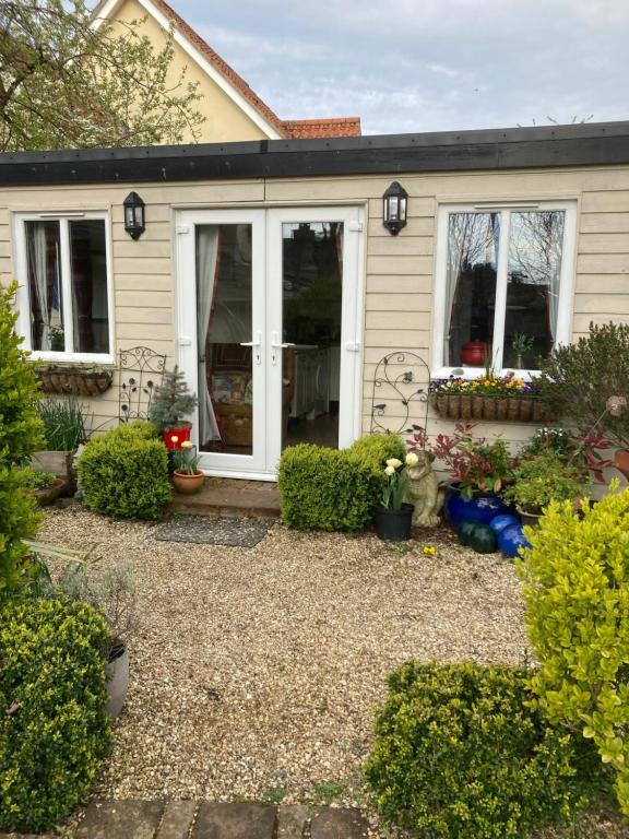 a house with a gravel yard in front of it at The Cabin in Hockham