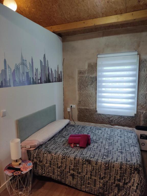 a bedroom with a bed with a red suitcase on it at Pleno Casco Vello, Céntrico, Reformado 2023 in Vigo