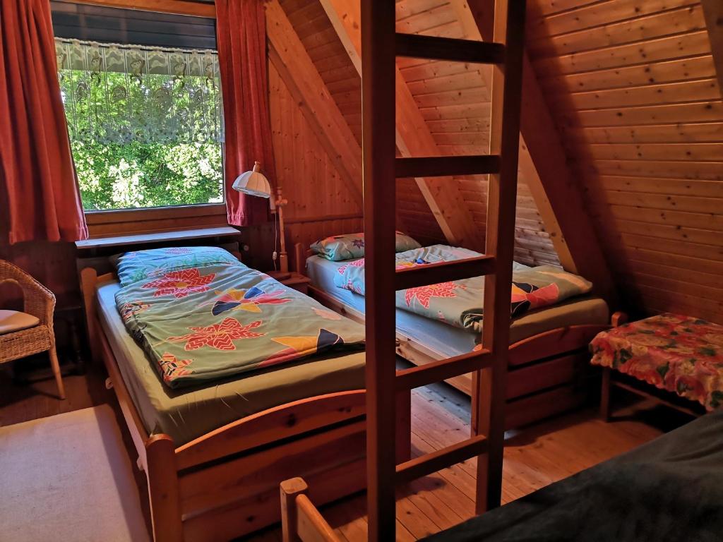 a bedroom with two bunk beds in a cabin at Haus Paradiesecke in Waldbrunn