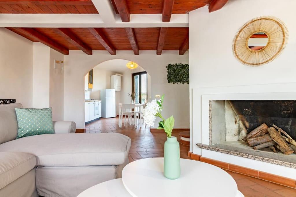 a living room with a couch and a fireplace at Su Trigu, primo piano in Bari Sardo