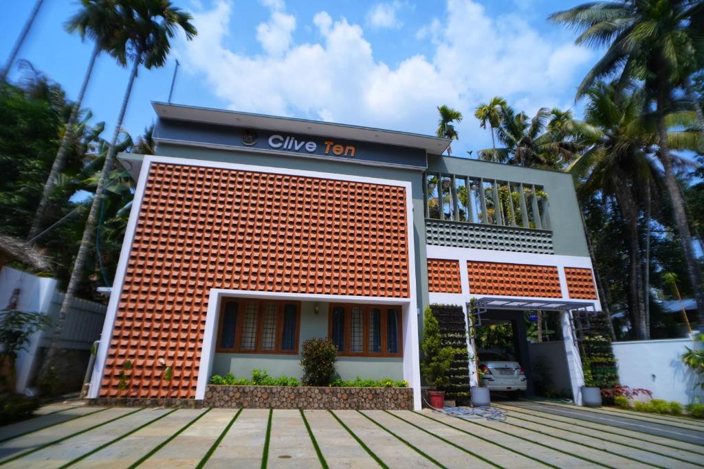 a building with a sign on the front of it at Clive Ten Resorts Athirapilly in Kizhake Chālakudi