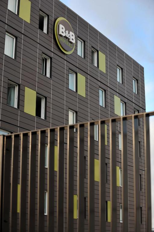 a building with a fedex sign on the side of it at B&B HOTEL Paris Le Bourget in Le Bourget
