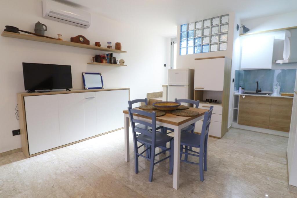 a kitchen with a table and chairs in a room at Malikas House Otranto in Otranto