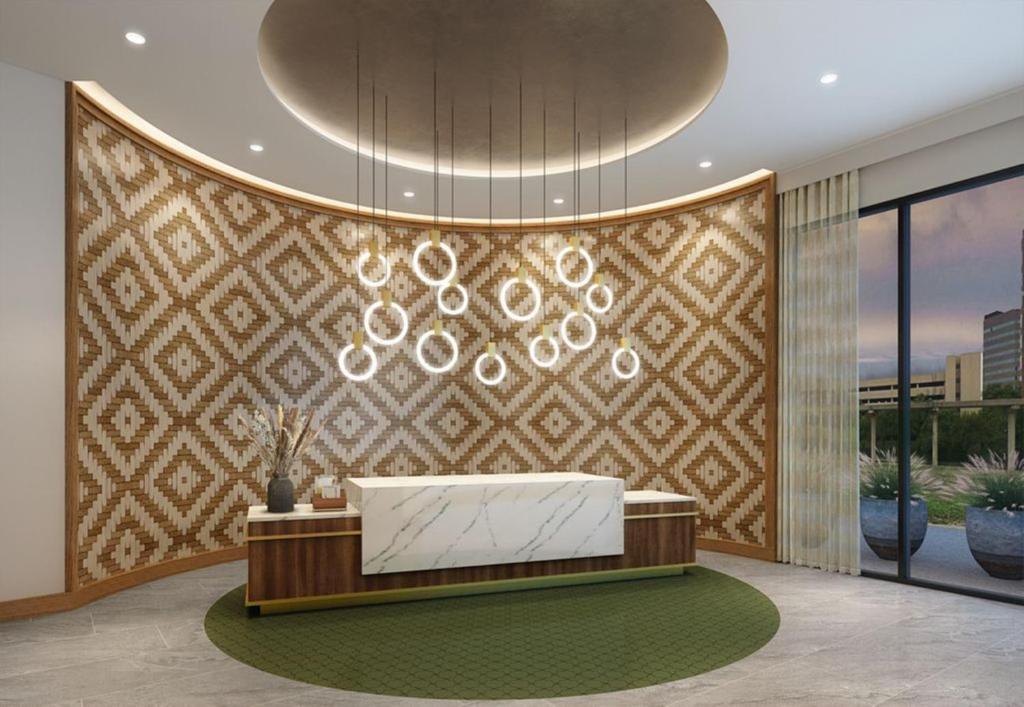 a lobby with a reception desk and a wall at Hotel Indigo Irving - Las Colinas, an IHG Hotel in Irving