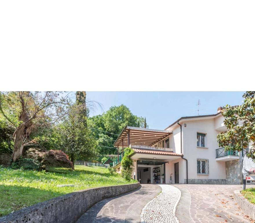 a house with a stone path in front of a house at Civico 7 in Clusane sul Lago