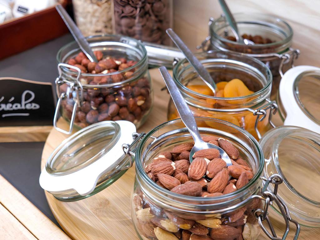 a group of jars filled with nuts and dried fruits at greet Hotel Belleville en Beaujolais A6 in Belleville-sur-Saône