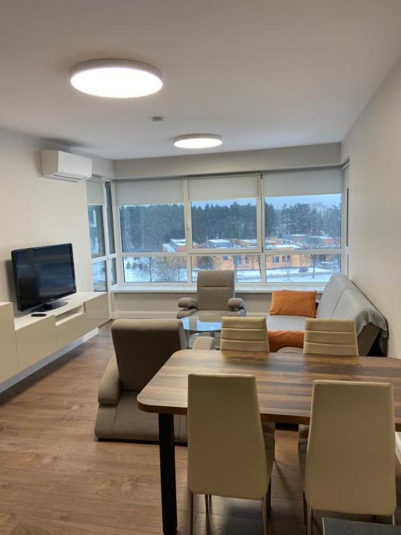 a living room with a table and a couch at Eliana Apartments in Druskininkai
