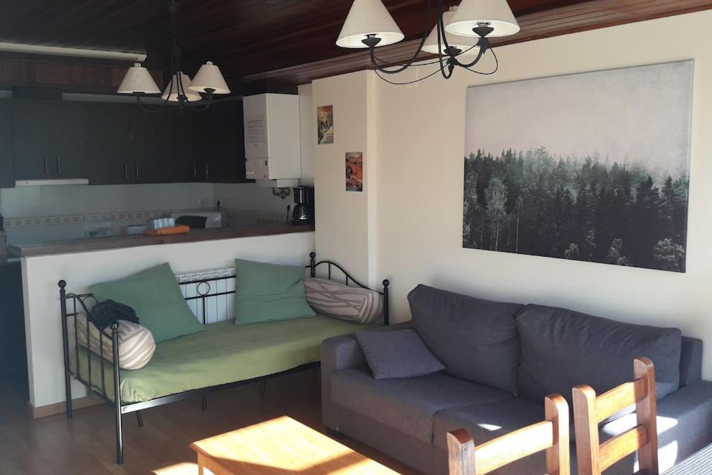 a living room with a couch and a kitchen at Ibones azules in Sallent de Gállego