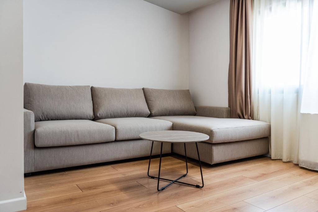 a living room with a couch and a table at Relax Inn Hotel Durres in Durrës