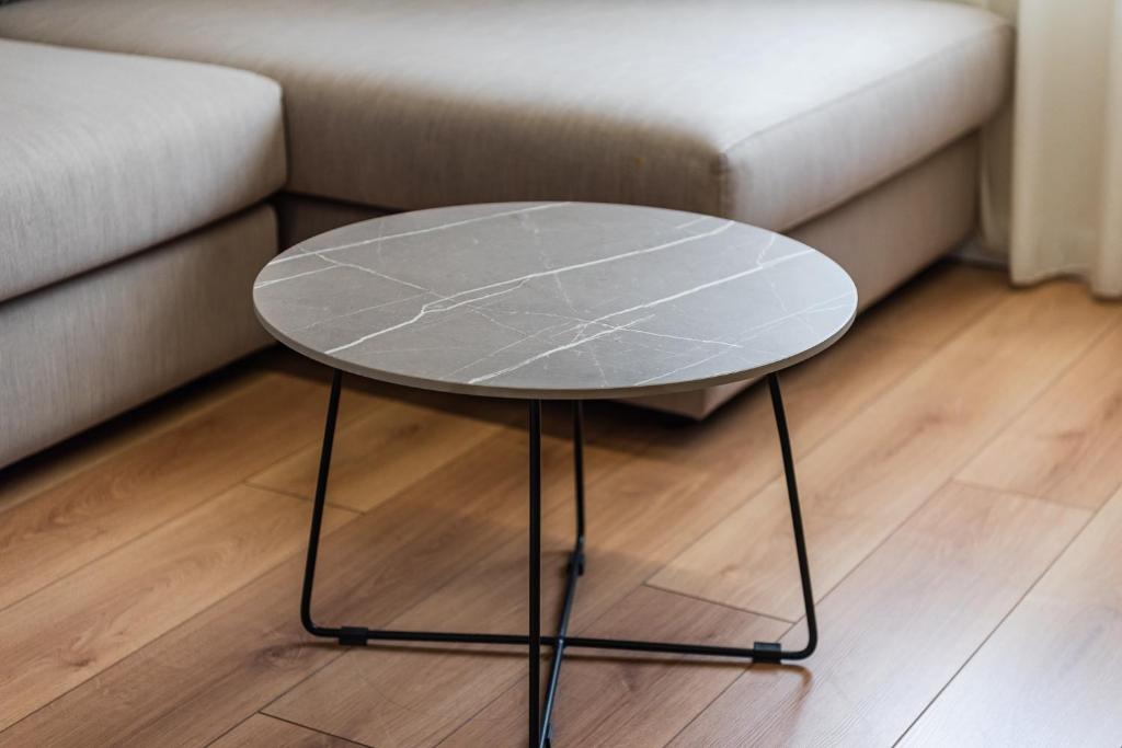 a glass coffee table in front of a couch at Relax Inn Hotel Durres in Durrës