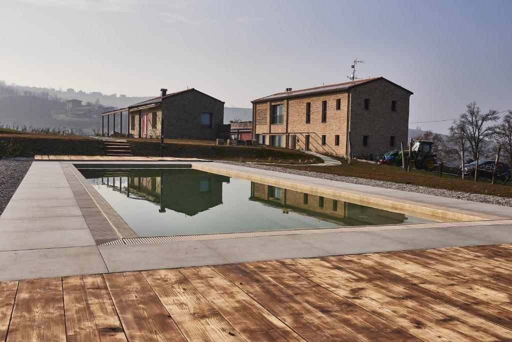a pool of water with buildings in the background at Agriturismo Prato del Re in Prignano sulla Secchia