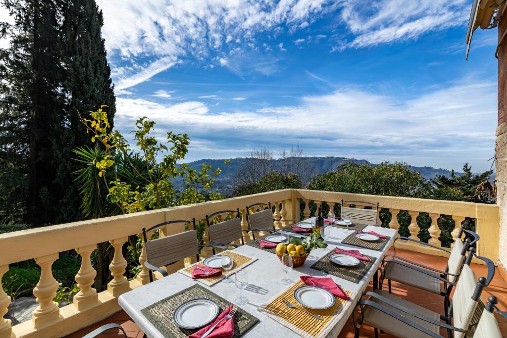 a table on the balcony of a house at Appartamento Giovanni - Relax Among Green - Happy Rentals in Camaiore