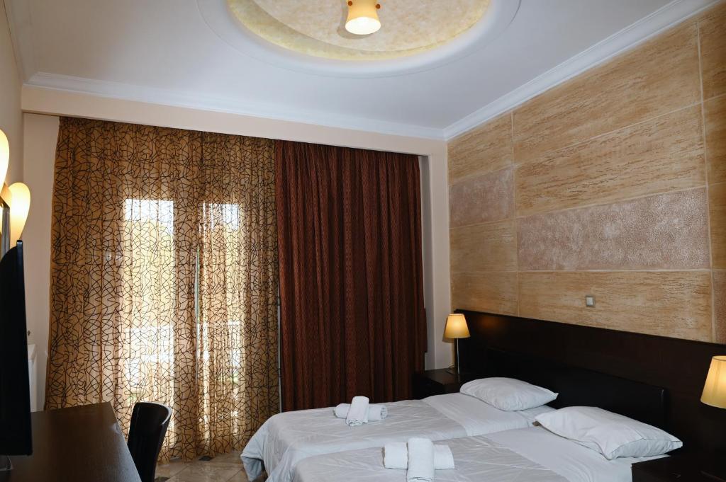 Postel nebo postele na pokoji v ubytování Aktis Hotel