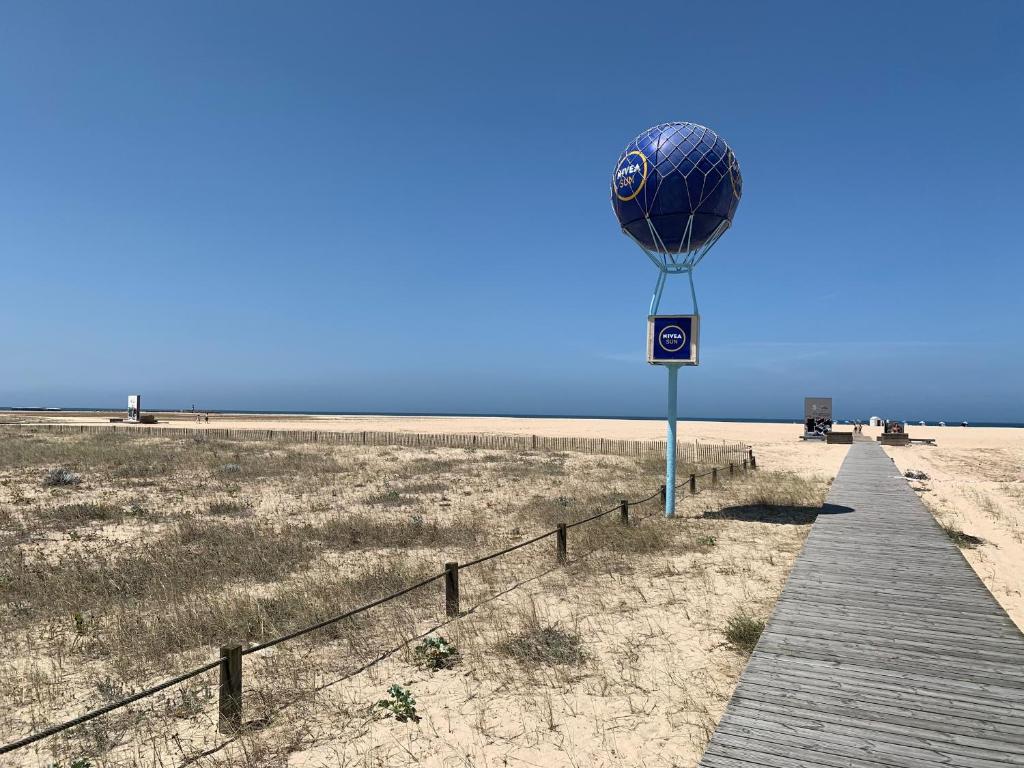 a hot air balloon on the beach with a boardwalk at Two bedroom apartment near beach and Casino in Figueira da Foz