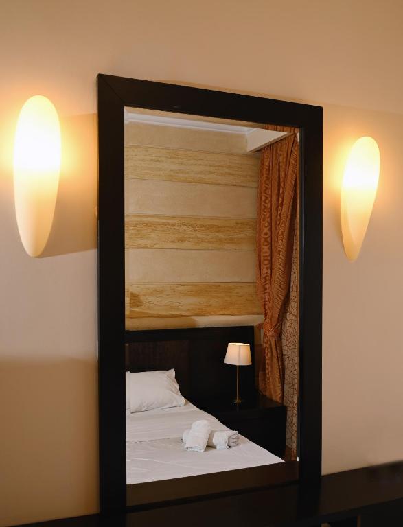 Postel nebo postele na pokoji v ubytování Aktis Hotel