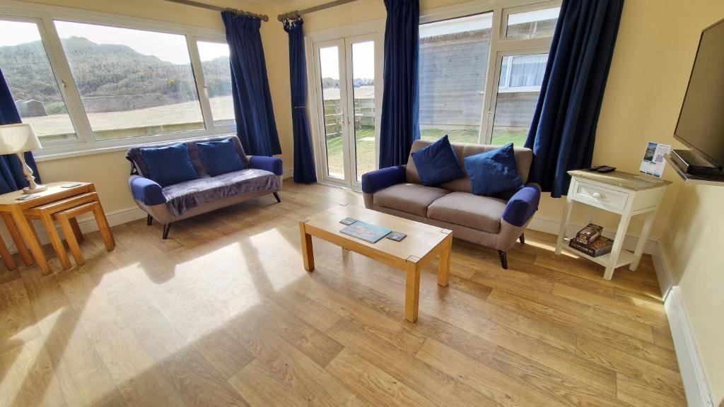 a living room with two couches and a coffee table at 5 The Burrows in Braunton
