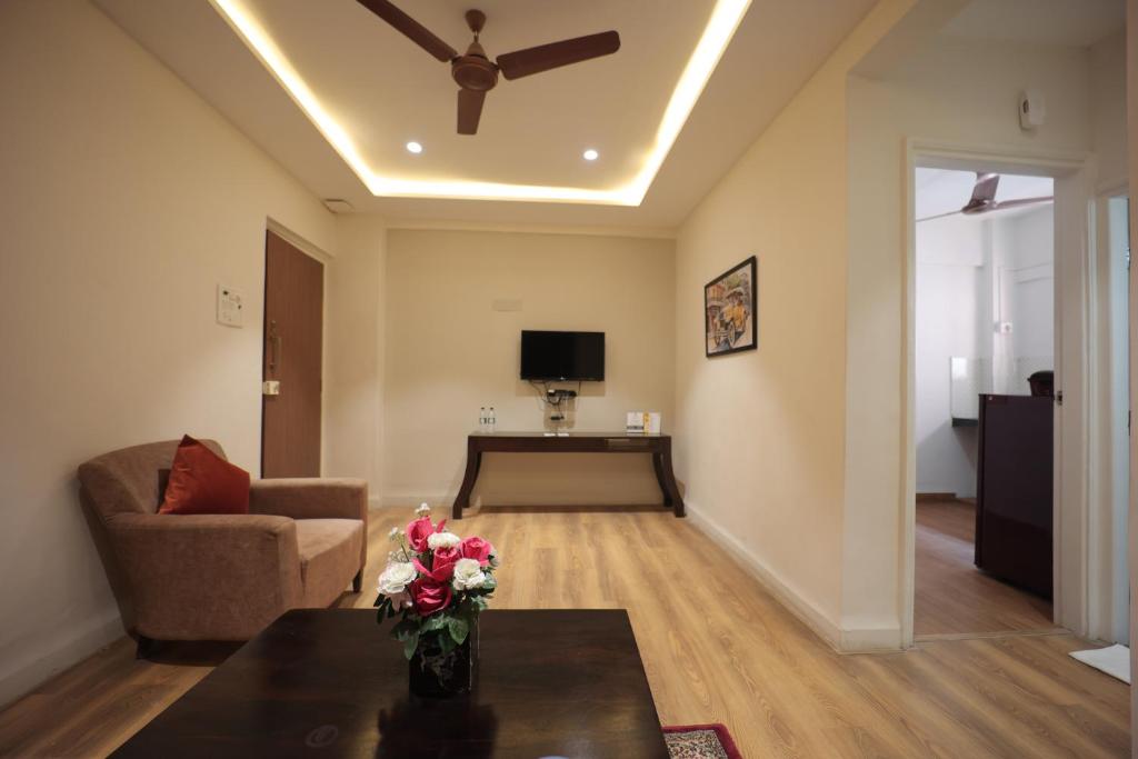 a living room with a ceiling fan and a couch at The Byke Studio Pure Veg Apartment, Thane in Thane
