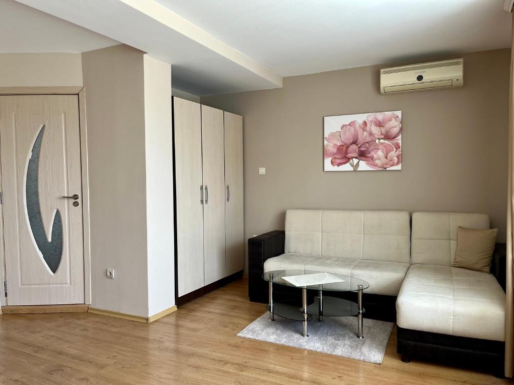 a living room with a couch and a table at Hotel Silver in Sozopol