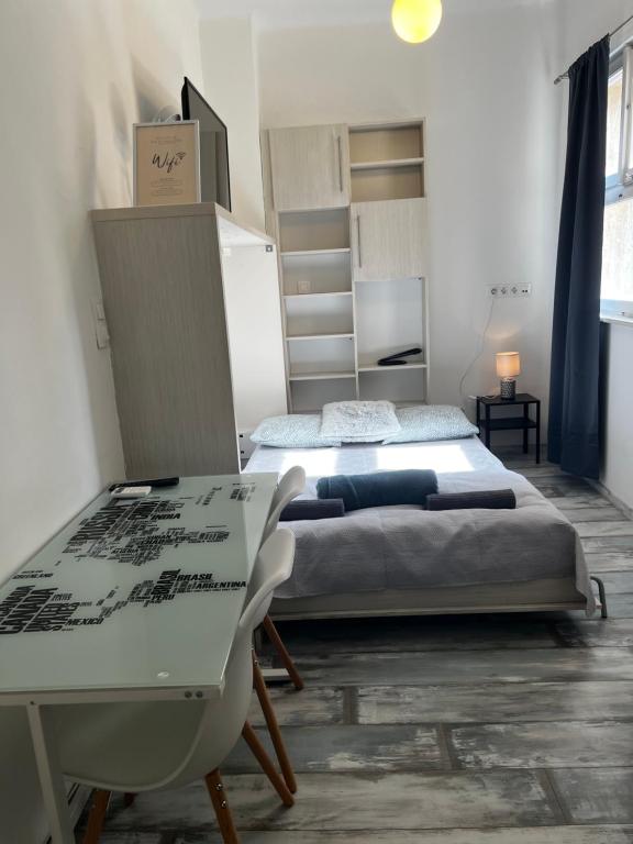 a bedroom with two beds and a table and a desk at BEM by Small Home Budapest in Budapest