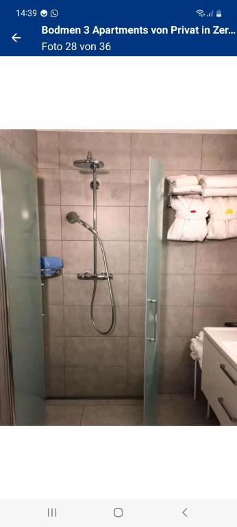 a bathroom with a shower with a glass door at Bodmen 3 Apartments von Privat in Zermatt in Zermatt
