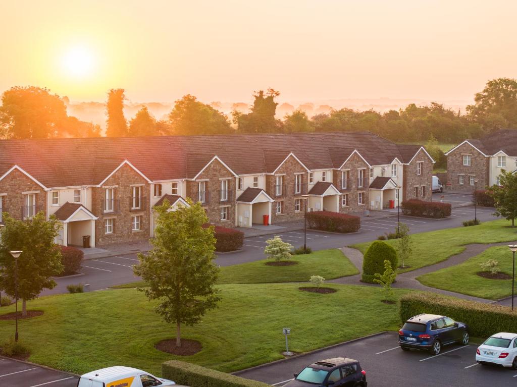 a group of houses in a parking lot at Knightsbrook Hotel Courtyard Accommodation in Trim