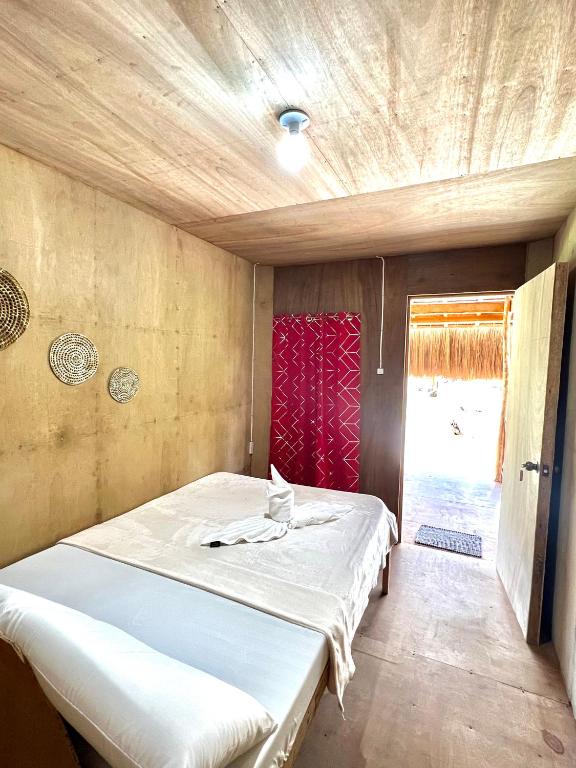 a small bedroom with a bed in a room at Cabanas Pacifico Siargao Tourist Inn in San Isidro