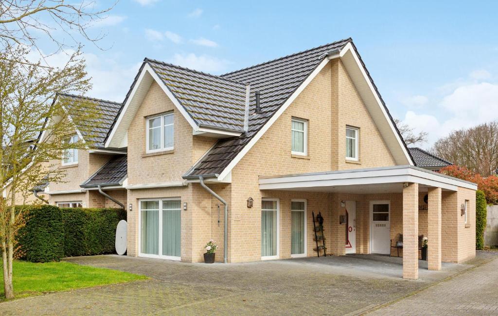 a brick house with a black roof at 3 Bedroom Stunning Home In Haren Ems in Dankern