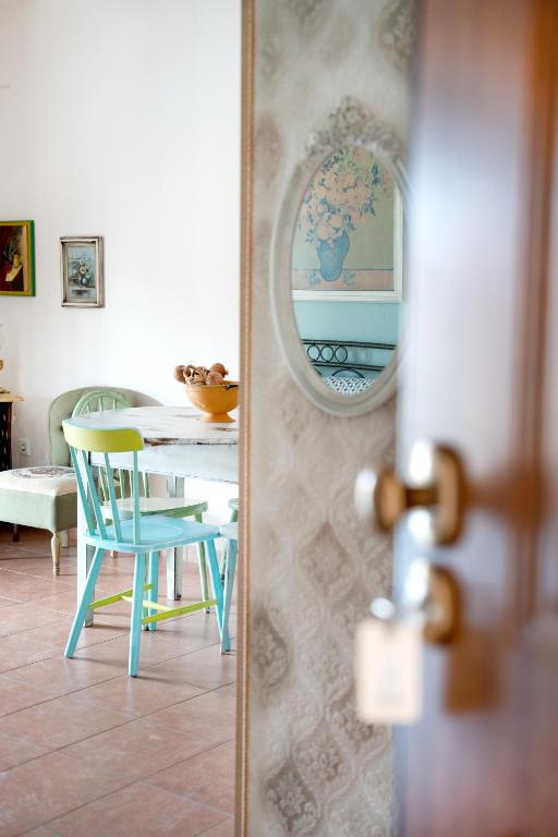 a dining room with a table and a mirror at Artistic 2 Apartment in Afitos