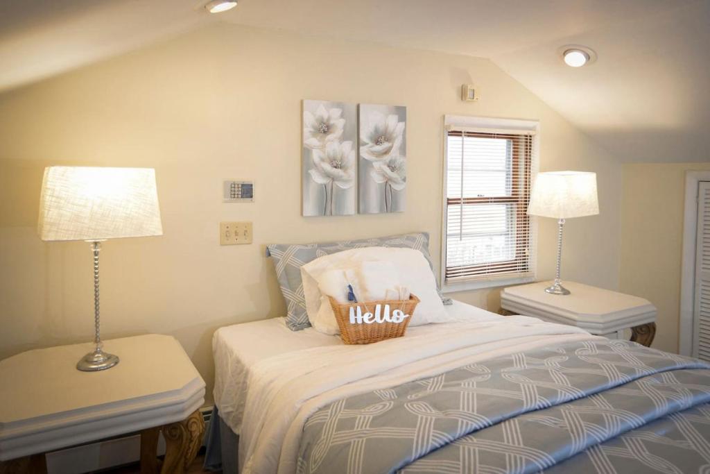 a bedroom with a bed and two tables and two lamps at Sunny 4 Bed 2 Bath Providence in Providence