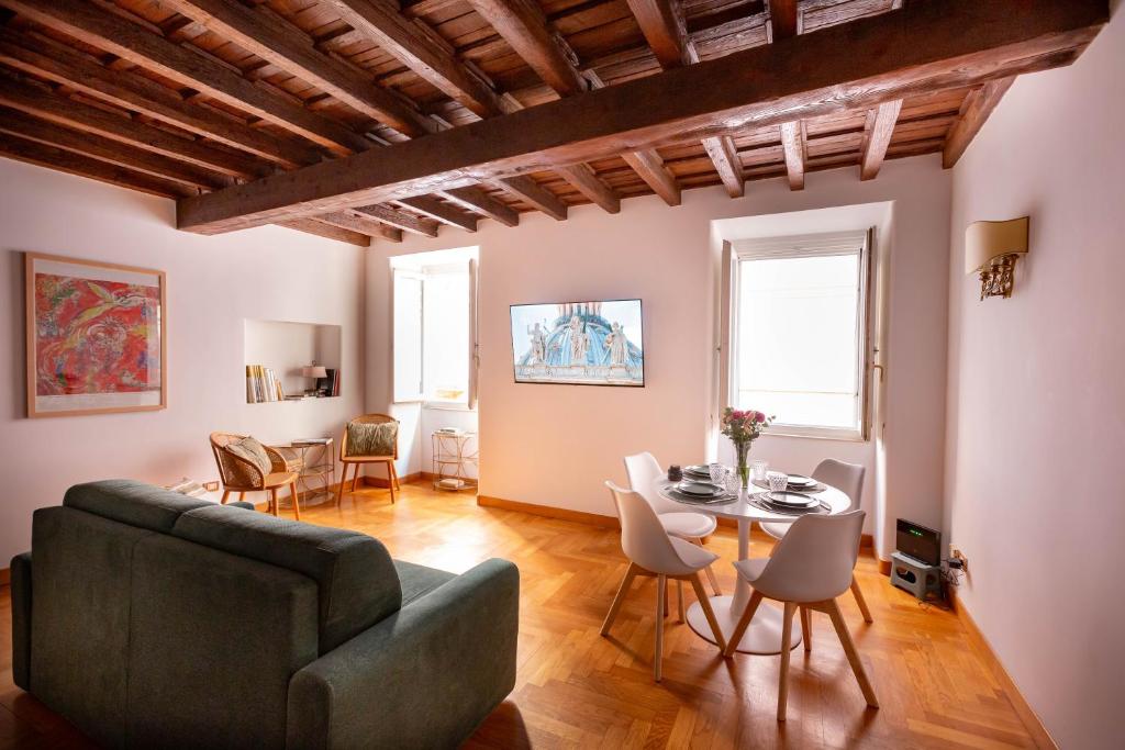 a living room with a couch and a table at Pantheon Luxury House - ZEN 28 in Rome
