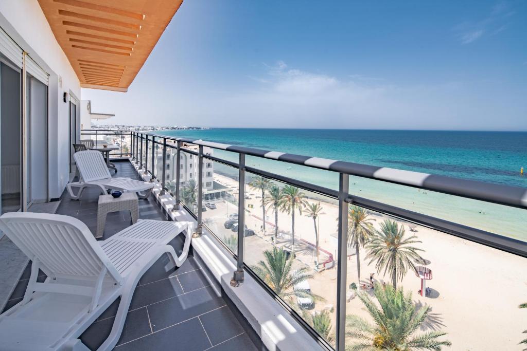 a balcony with chairs and a view of the beach at Novostar Apart Monte Carlo Sea View in Sousse