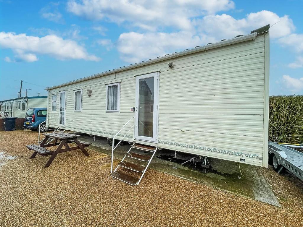 a large white trailer with a ladder and a table at 6 Berth Dog Friendly Caravan In Hunstanton In Norfolk Ref 13014l in Hunstanton