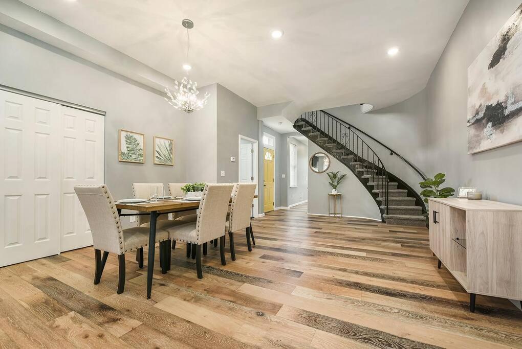 a dining room with a table and chairs and a staircase at Luxury Living in Lawrenceville! in Pittsburgh