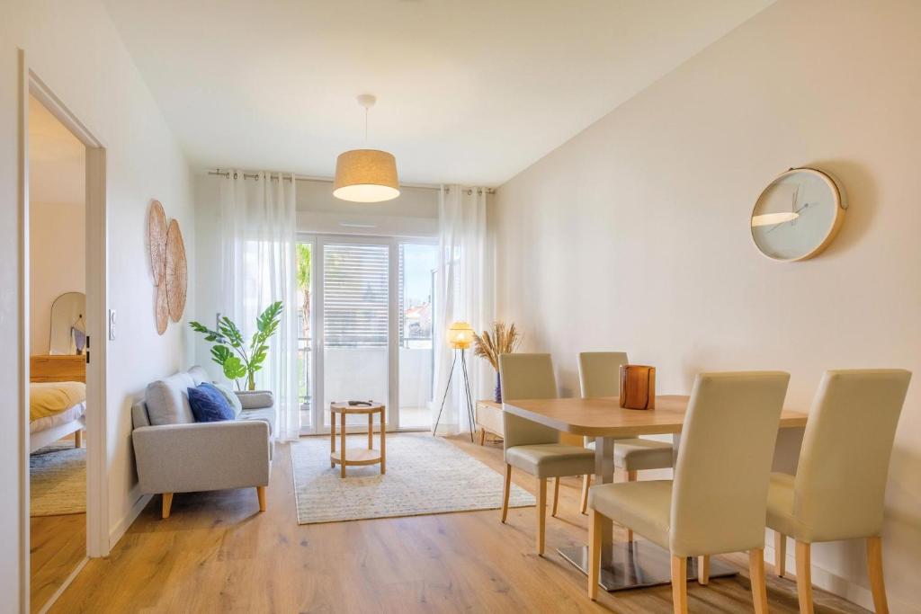 une salle à manger et un salon avec une table et des chaises dans l'établissement OVELIA Fréjus - La Villa Marina, à Fréjus