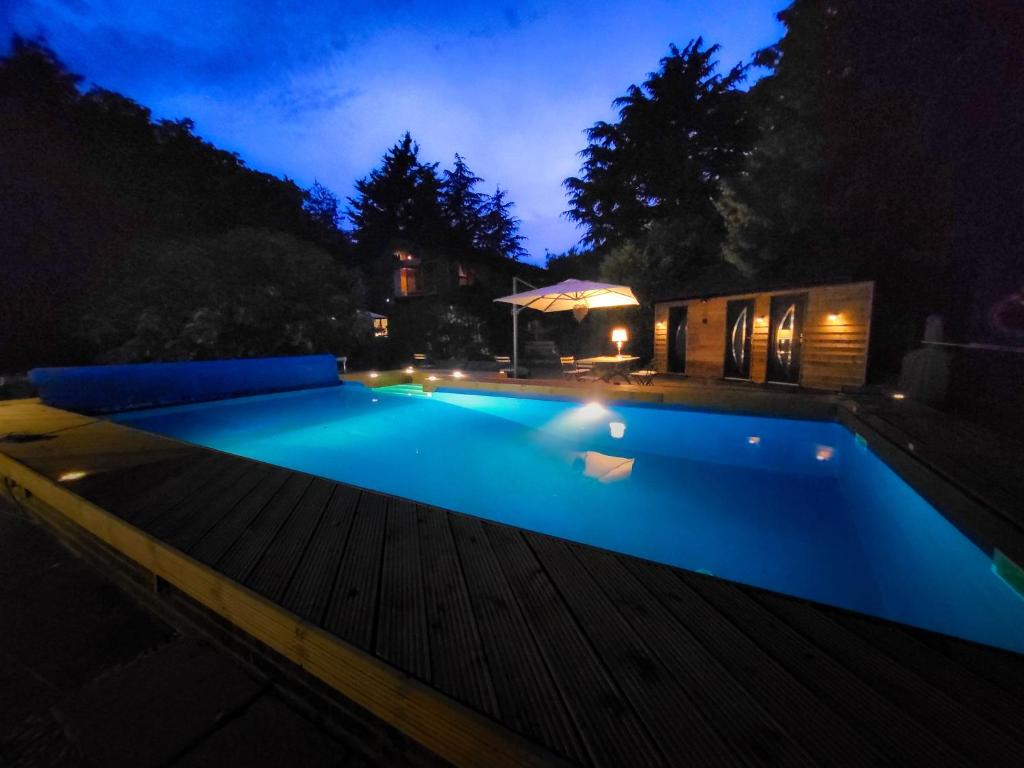 a swimming pool in a backyard at night at Retreat by the Mill - for a relaxing getaway in Cottered