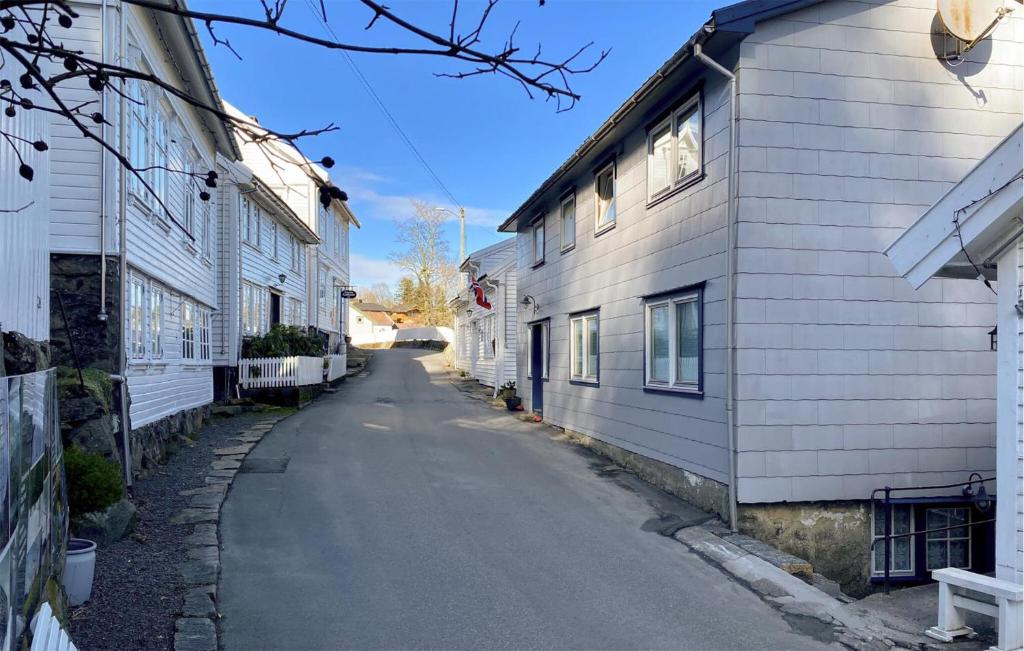 an empty alleyway between two white buildings at 1 Bedroom Stunning Apartment In Hauge I Dalane in Sogndalsstrand