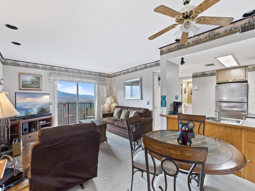a living room and kitchen with a ceiling fan at Deer Ridge Mountain Resort D204 in Gatlinburg