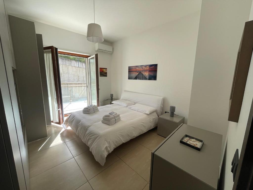 a small bedroom with a bed and a window at Casa Adele in Salerno