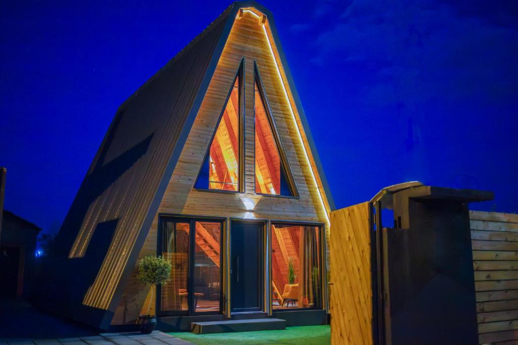 a house with a triangular roof with a large window at KOVU chalet in Drama