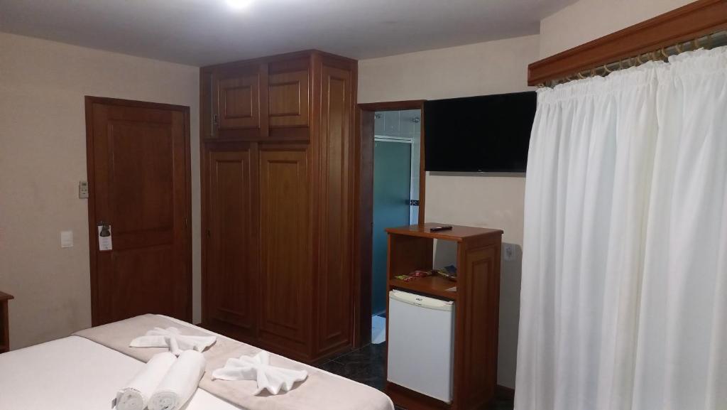 Postel nebo postele na pokoji v ubytování Canzi Cataratas Hotel
