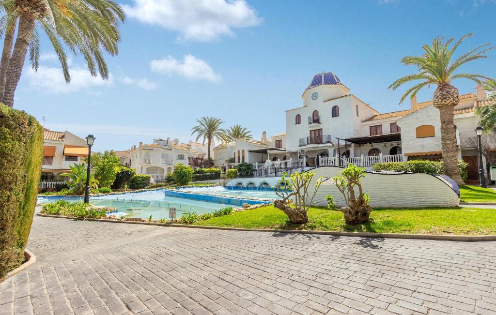 een resort met een zwembad en een gebouw bij Cozy Home In Gran Alacant With Outdoor Swimming Pool in Gran Alacant