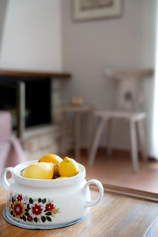 a cup filled with lemons sitting on a table at Artistic 1 apartment in Afitos
