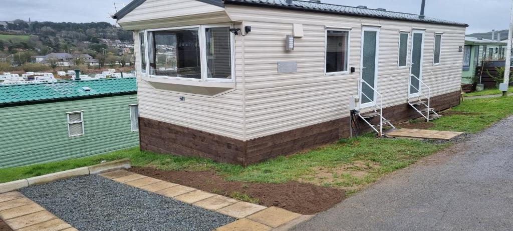 a tiny house with a window on the side of it at Light and Airy 2 Bedroom Mobile Home in Aberystwyth